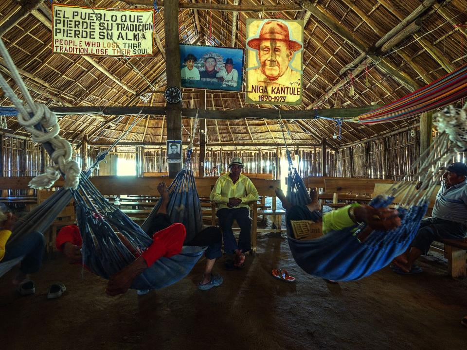 Guna Indigenous community leaders lie on hammocks in a building on the island of Carti Sugtupu.