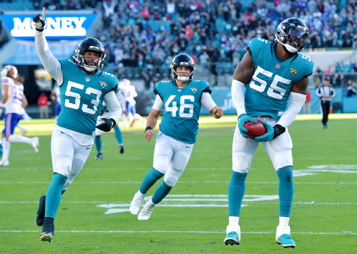 Jaguars linebacker Dakota Allen (53) and Jacksonville Jaguars long snapper Ross Matiscik (46) celebrate after defensive end Lerentee McCray's (55) picks up the final punt of the game against Buffalo. Bob Self/Florida Times-Union