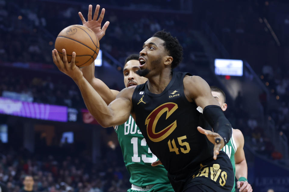 Cleveland Cavaliers guard Donovan Mitchell (45) shoots against Boston Celtics guard Malcolm Brogdon during the first half of an NBA basketball game, Monday, March 6, 2023, in Cleveland. (AP Photo/Ron Schwane)