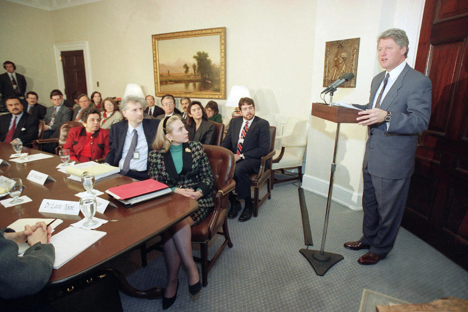 FILE - President Bill Clinton speaks during a meeting at the White House, Washington, Jan. 25, 1993 with members of the president's Task Force on National Health Reform. The president named his wife, first lady Hillary Rodham Clinton, seated center, to chair the group. At left beside Mrs. Clinton is Senior Policy Adviser Ira Magazine. (AP Photo/Greg Gibson, File)