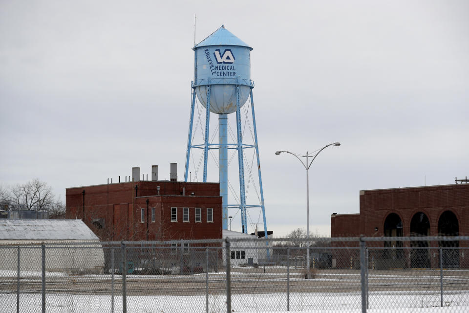 FILE - In this March 12, 2019 file photo, the water tower stands over the Veterans Affairs campus, in Knoxville, Iowa. After watching for more than a decade as a once busy Veterans Affairs campus deteriorated into a sprawling ghost town, leaders of a small Iowa city announced plans to take control of the property and likely demolish most of the structures. City and county officials signed documents Wednesday, Jan. 15, 2020, taking ownership of the 153-acre property. (AP Photo/Charlie Neibergall, File)