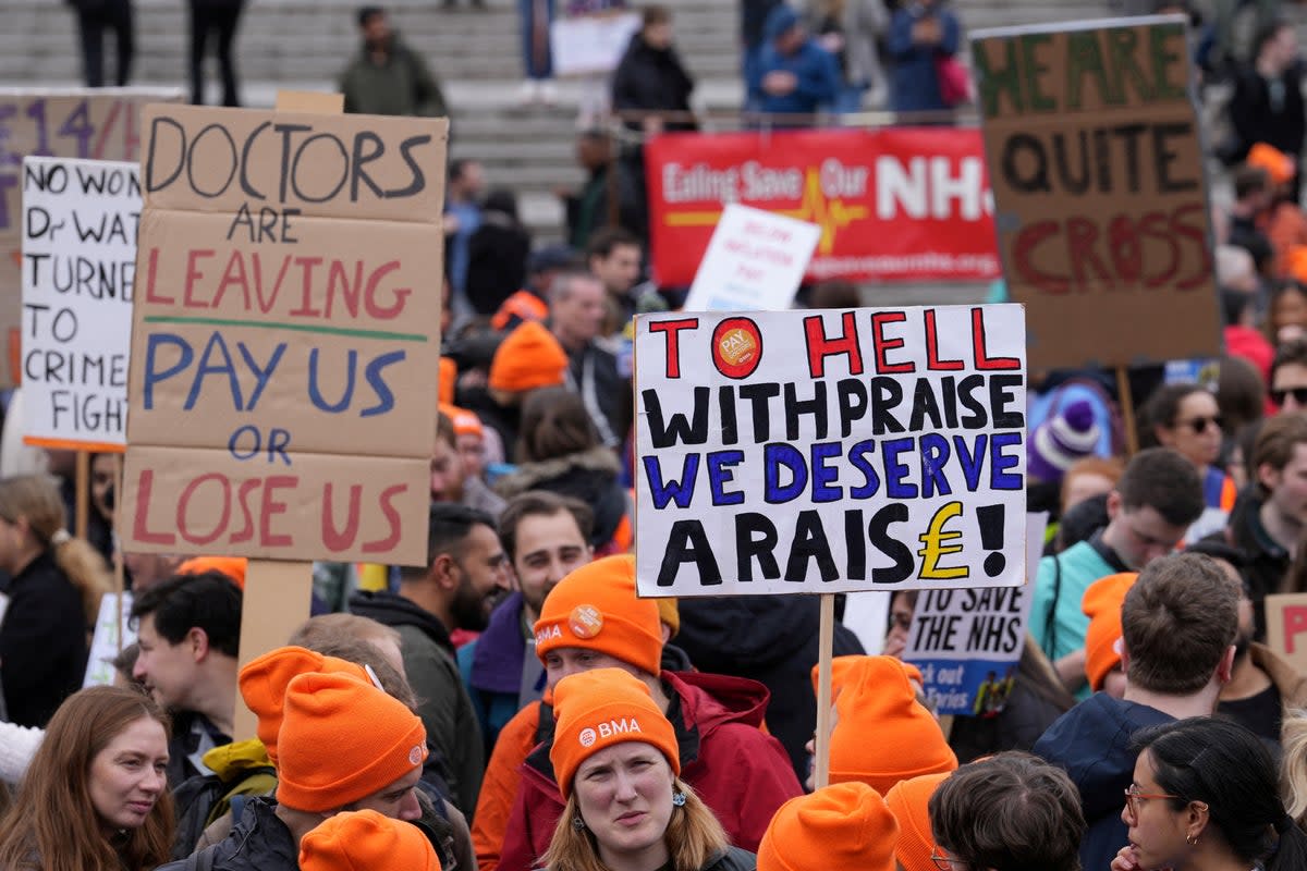 Junior doctors hold placards during a strike in April  (REUTERS)