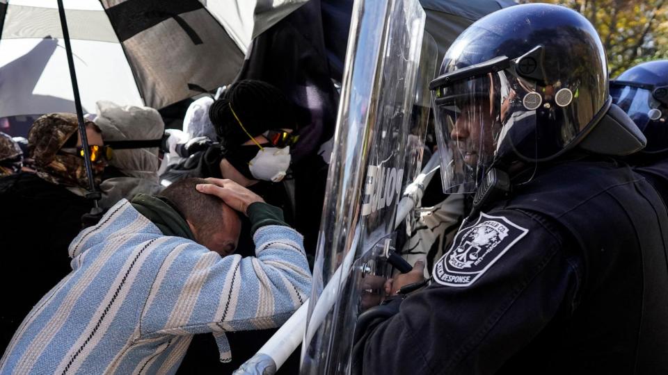 PHOTO: Protesters drive into a police line during a demonstration in opposition to a new police training center, Nov. 13, 2023, in Atlanta. (Mike Stewart/AP Photo)