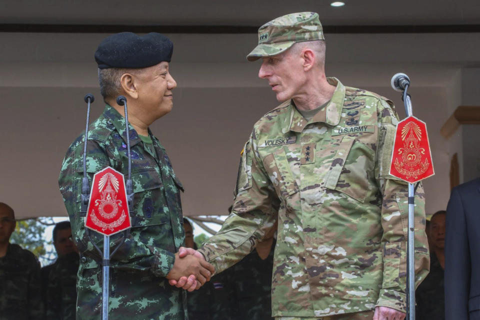 In this photo by release Royal Thai Armed Forced Headquarters, The Royal Thai Armed Forces, Gen. Pornpipat Benyasri, left shakes hands with Commander, U.S. Army First Corps representing U.S. Indo-Pacific Command Lt. Gen. Gary J. Volesky during the opening ceremony of the joint military exercise Cobra Gold 2019, Phitsanulok Province, Thailand. Tuesday, Feb. 12, 2019. The exercise will take place from Feb. 12-22 focusing on military Field Training Exercise, Humanitarian Civic Assistance to communities and Humanitarian Assistance and Disaster Relief Exercise. (Royal Thai Armed Forced Headquarters via AP)