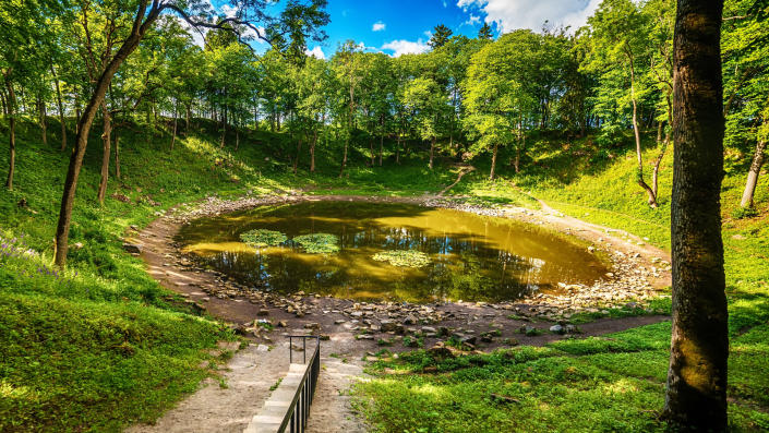 <p> <strong>&#x2013; Location:&#xA0;</strong>Kaali, Estonia </p> <p> <strong>&#x2013; Diameter:</strong>&#xA0;Largest crater 360 ft (110 meters) </p> <p> <strong>&#x2013; Depth:</strong>&#xA0;Largest crater 72 ft (22 meters) </p> <p> <strong>&#x2013; Age:</strong>&#xA0;Estimates ranging from 8400 to 2420 years old </p> <p> Why visit one crater when you can visit nine? Located on Saaremaa, Estonia&apos;s largest island, the Kaali crater field lies 11 miles (18 km) from the island capital which consists of one large crater and eight smaller craters according to the news site&#xA0;The Baltic Times. </p> <p> Remarkably, the island is thought to have already been inhabited at the time of the meteorite impact approximately 1530-1549 BCE&#xA0;according to a study published in Meteoritics and Planetary Science, though the age is still a matter of debate and estimates range from 2,420 years to 8,400 years old.&#xA0; </p> <p> The scientific and cultural significance of the Kaali crater field can be explored in great detail at the&#xA0;Kaali Meteoritics and Limestone Museum. Here you can also view various fossils on display and learn about other discoveries made on the island of Saaremaa. A guide service is available in Estonian, English, Finnish and Russian and there is also a gift shop.&#xA0; </p>