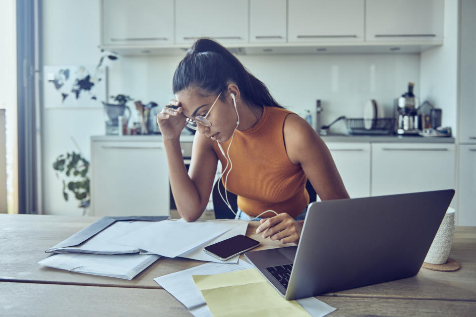 Woman looking at financial paperwork at home