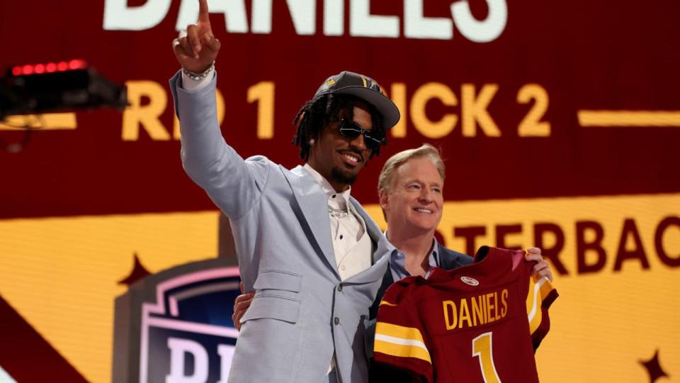 <div>DETROIT, MICHIGAN - APRIL 25: Jayden Daniels poses with NFL Commissioner Roger Goodell after being selected second overall by the Washington Commanders during the first round of the 2024 NFL Draft at Campus Martius Park and Hart Plaza on April 25, 2024 in Detroit, Michigan. (Photo by Gregory Shamus/Getty Images)</div>