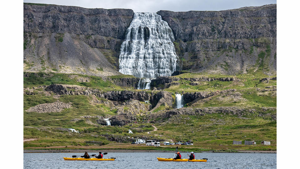 Travelers kayaking to Dynjandi waterfall. - Credit: Christopher Scholey