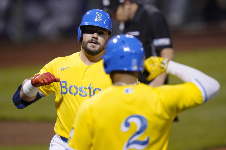 Boston Red Sox's Kyle Schwarber, left, is congratulated by Xander Bogaerts (2) after his solo home run off New York Mets starting pitcher Taijuan Walker during the first inning of a baseball game at Fenway Park, Wednesday, Sept. 22, 2021, in Boston. (AP Photo/Charles Krupa)