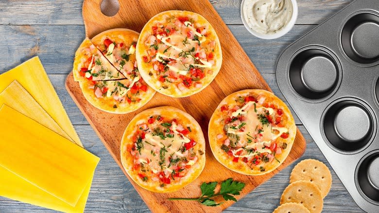 Mini pizzas with tools and ingredients