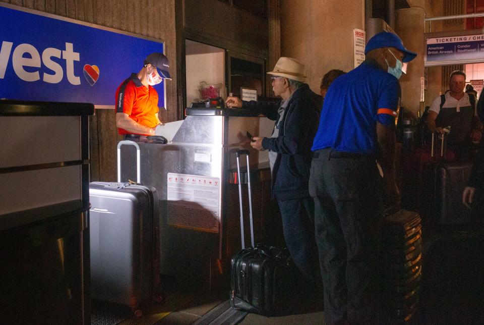 Passengers wait for the power to be restored, Nov. 8, 2021, in Terminal 4 at Sky Harbor International Airport, Phoenix, Arizona.