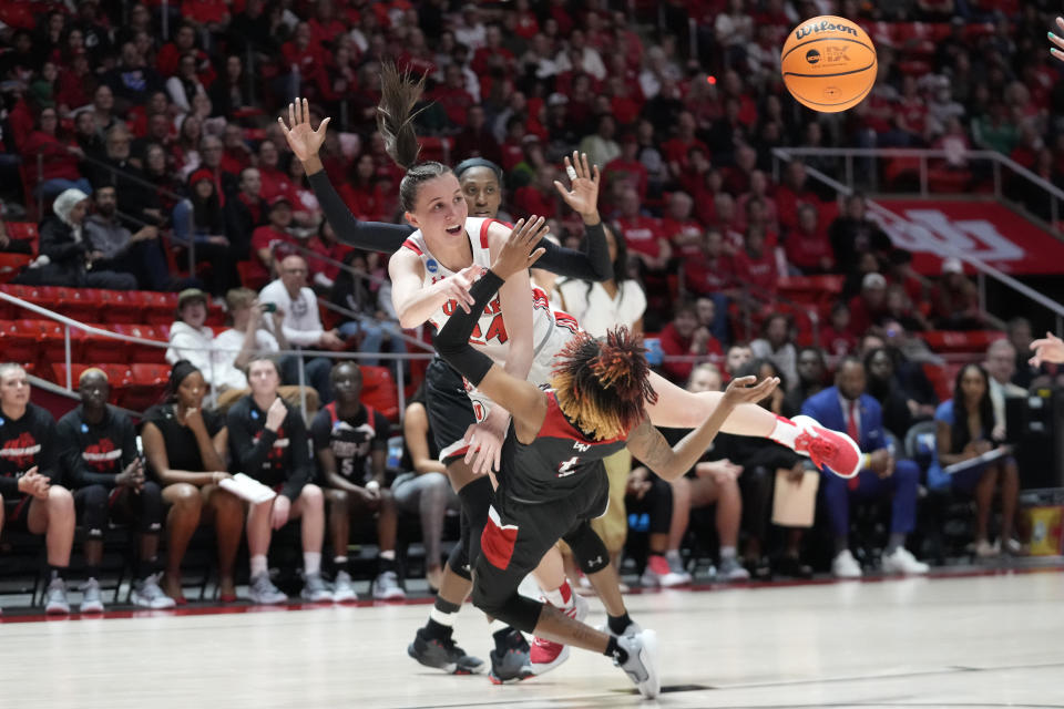 Gardner-Webb guard Ki'Ari Cain (1) defends as Utah guard Kennady McQueen (24) passes the ball during the first half of a first-round college basketball game in the women's NCAA Tournament, Friday, March 17, 2023, in Salt Lake City. (AP Photo/Rick Bowmer)