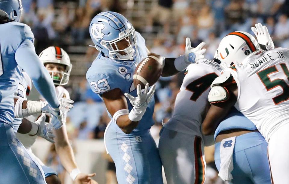 UNC linebacker Cedric Gray (33) intercepts the ball to effectively end the game during North Carolina’s 45-42 victory over Miami at Kenan Stadium in Chapel Hill, N.C., Saturday, October 16, 2021.