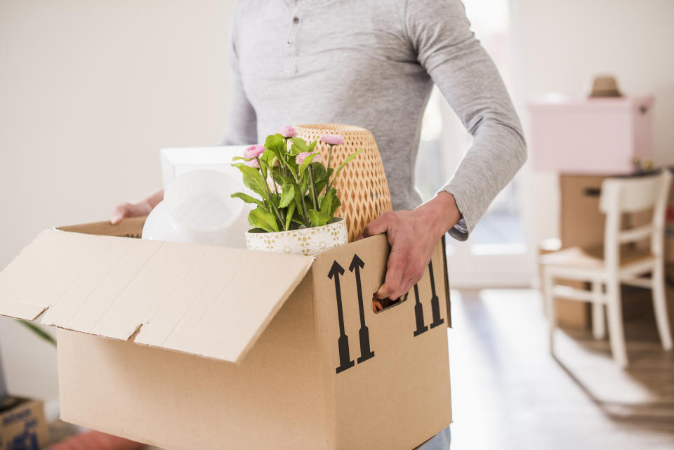 A person holding a box of personal items