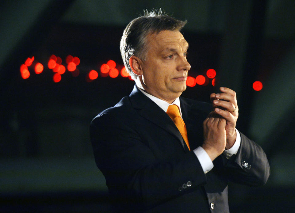 Hungarian Prime Minister Viktor Orban, leader of the ruling center-right Fidesz party applauds prior to his victory speech after the parliamentary elections in downtown Budapest, Hungary, late Sunday, April 6, 2014. (AP Photo/MTI, Laszlo Beliczay)