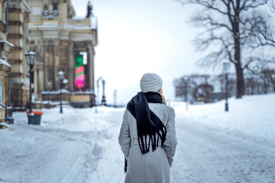 woman walking on snowy street
