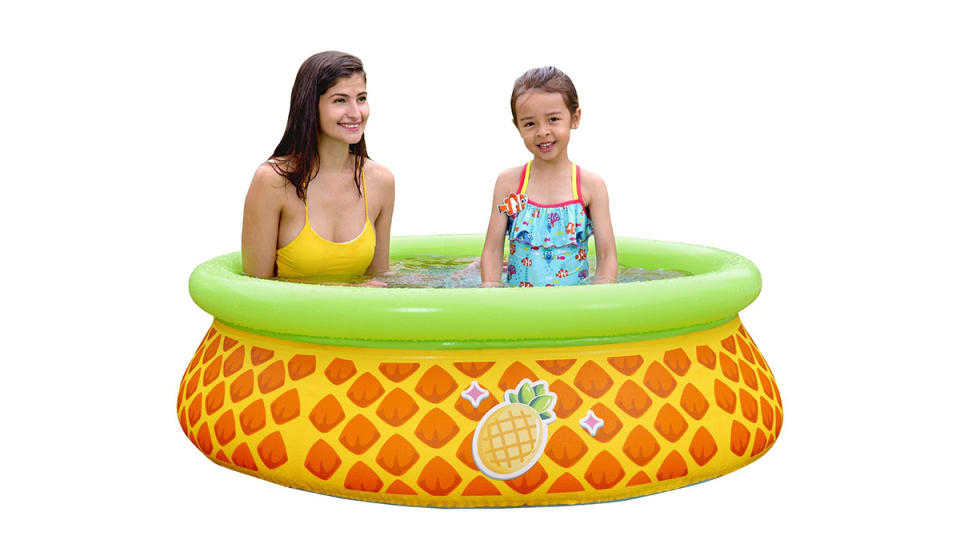 Woman and child swimming in inflatable pool