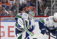 Vancouver Canucks goalie Arturs Silovs (31) makes a save against the Edmonton Oilers during the third period of Game 3 of an NHL hockey Stanley Cup second-round playoff series in Edmonton, Alberta, Sunday, May 12, 2024. (Jason Franson/The Canadian Press via AP)