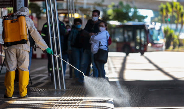 A member of a municipal sanitisation crew use mixing of sodium hypochlorite and water to disinfect and eliminate viruses and bacteria from the bus terminals in Sao Paulo, Brazil. 