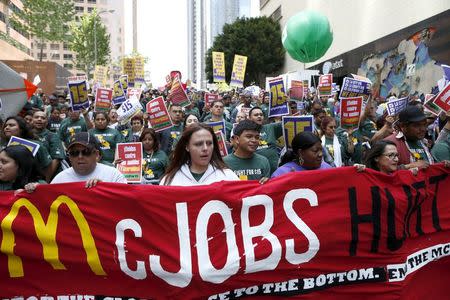 People protest for a $15-an-hour nationwide minimum wage in Los Angeles, California, United States, April 14, 2016. REUTERS/Lucy Nicholson