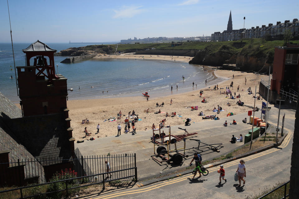 Sunbathers on Cullercoats Beach.