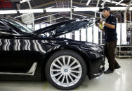 A worker closes the hood on a locally assembled new BMW 7 Series on the production line at a Gaya Motor assembly plant in Jakarta, Indonesia November 30, 2016. REUTERS/Darren Whiteside