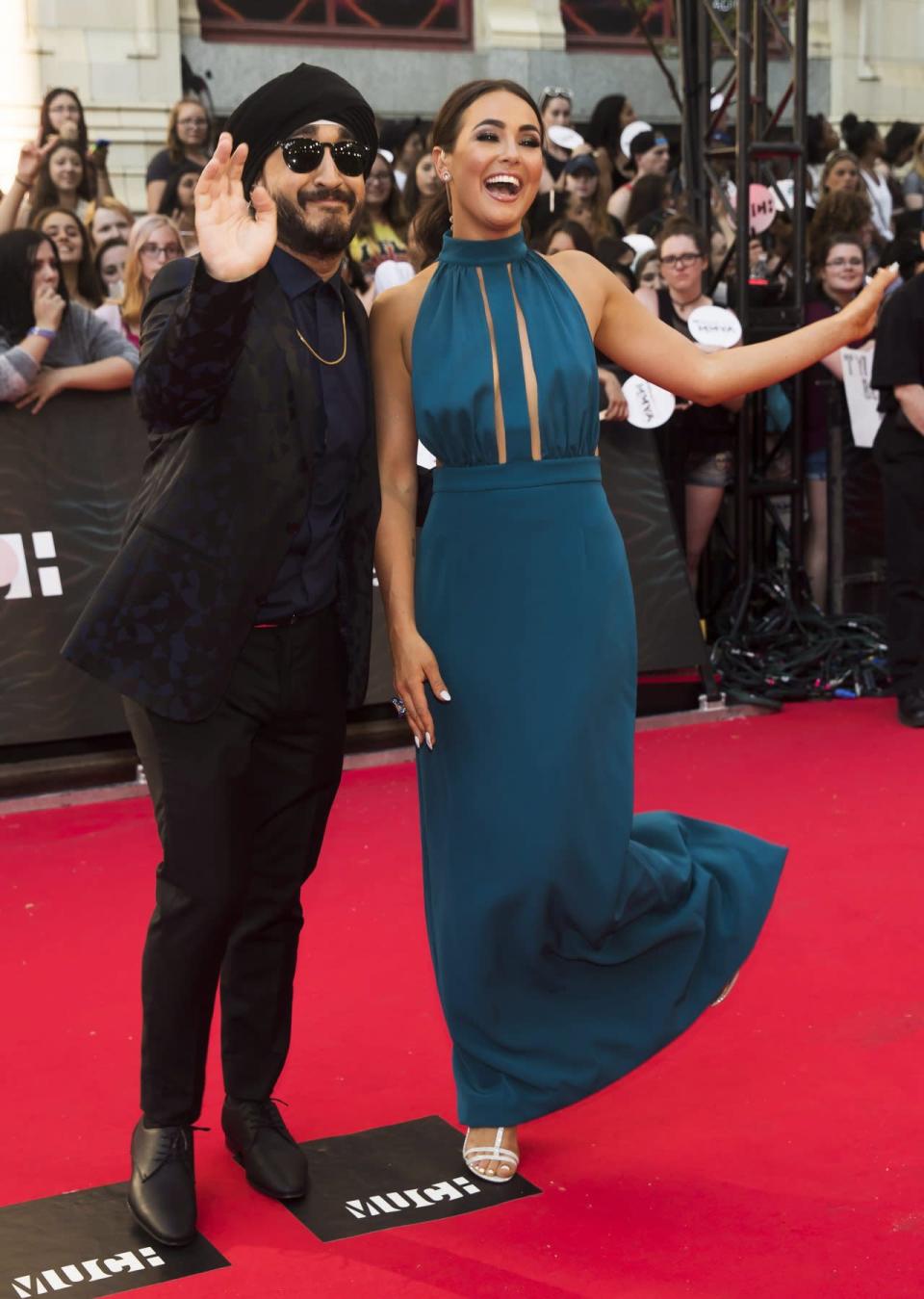<p>Jus Reign wore a subtley-printed suit jacket while Chloe Wilde looked elegant in a column gown. <i>(THE CANADIAN PRESS/Mark Blinch)</i><br></p>