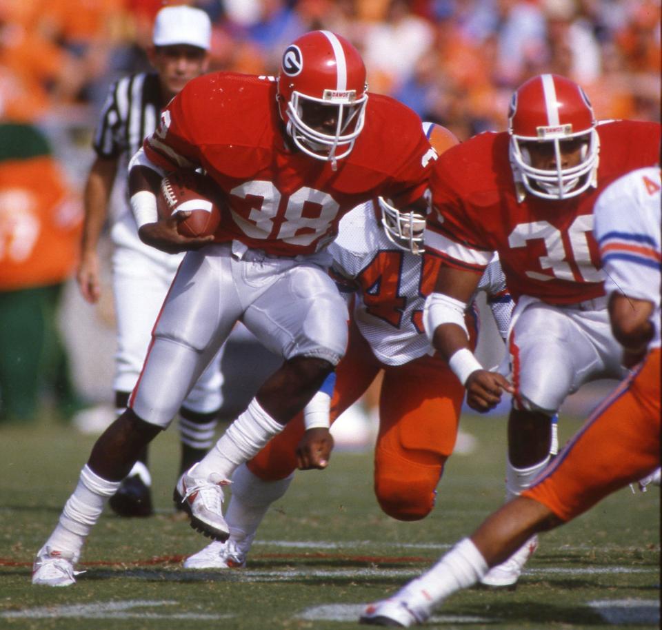 FILE/ The Times-Union -- 1985 Game -- Times-Union file photo from Florida vs. Georgia game 11/9/85 as UGA RB Tim Worley (38) running beside Keith Henderson (30) during the game that featured an 89-yard TD run by Worley.  (The Florida Times-Union/File)