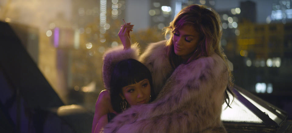 This image released by STXfilms shows Constance Wu, left, and Jennifer Lopez in a scene from "Hustlers," in theaters on Sept. 13. (Barbara Nitke/STXfilms via AP)