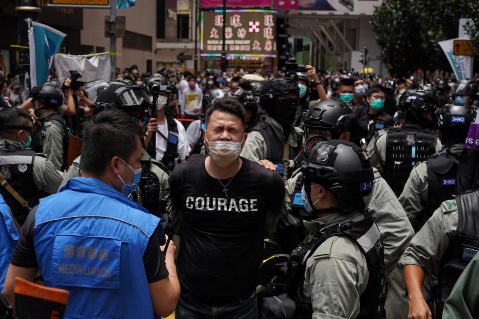 Andrew Wan, a pro-democracy lawmaker, is arrested by riot police during a protest in Hong Kong on July 1, 2020. | Yat Kai Yeung—NurPhoto/Getty Images