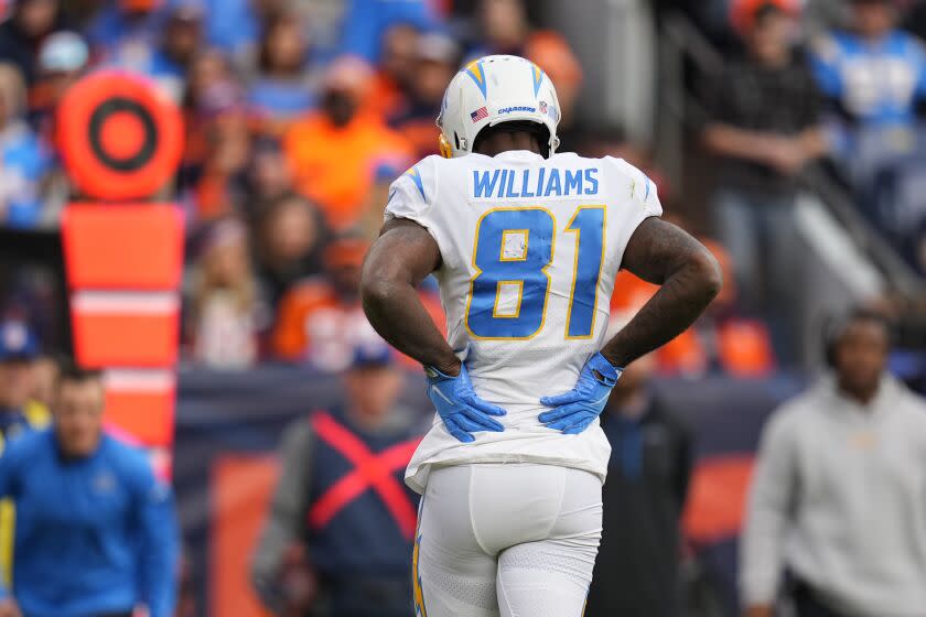 Los Angeles Chargers wide receiver Mike Williams (81) holds his injured back against the Denver Broncos