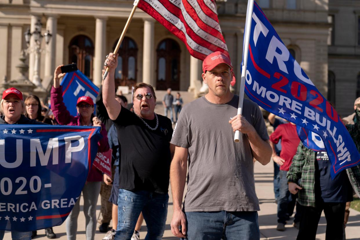 Trump supporters demonstrating the election results face off with counter protesters at the State Capitol in Lansing, Michigan (AP)