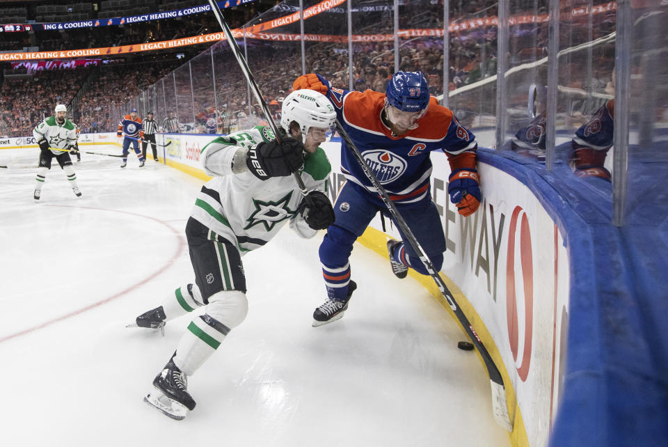 Dallas Stars' Wyatt Johnston (53) and Edmonton Oilers' Connor McDavid (97) battle for the puck during the second period of Game 3 of the NHL hockey Western Conference Final in Edmonton, Alberta, Monday, May 27, 2024. (Jason Franson/The Canadian Press via AP)