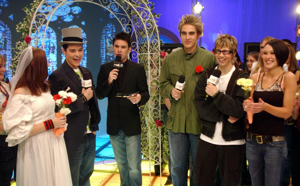 MTV presenter Dave Berry (centre) plays vicar during a make-believe wedding between a fan and Matt Willis from boyband Busted during their guest appearance on MTV's TRL UK at the MTV Studios in Camden, north London. The boys are currently promoting their latest single 