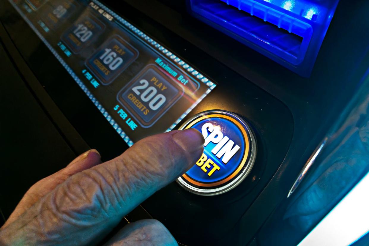 A customer plays a video poker machine in Galesburg.