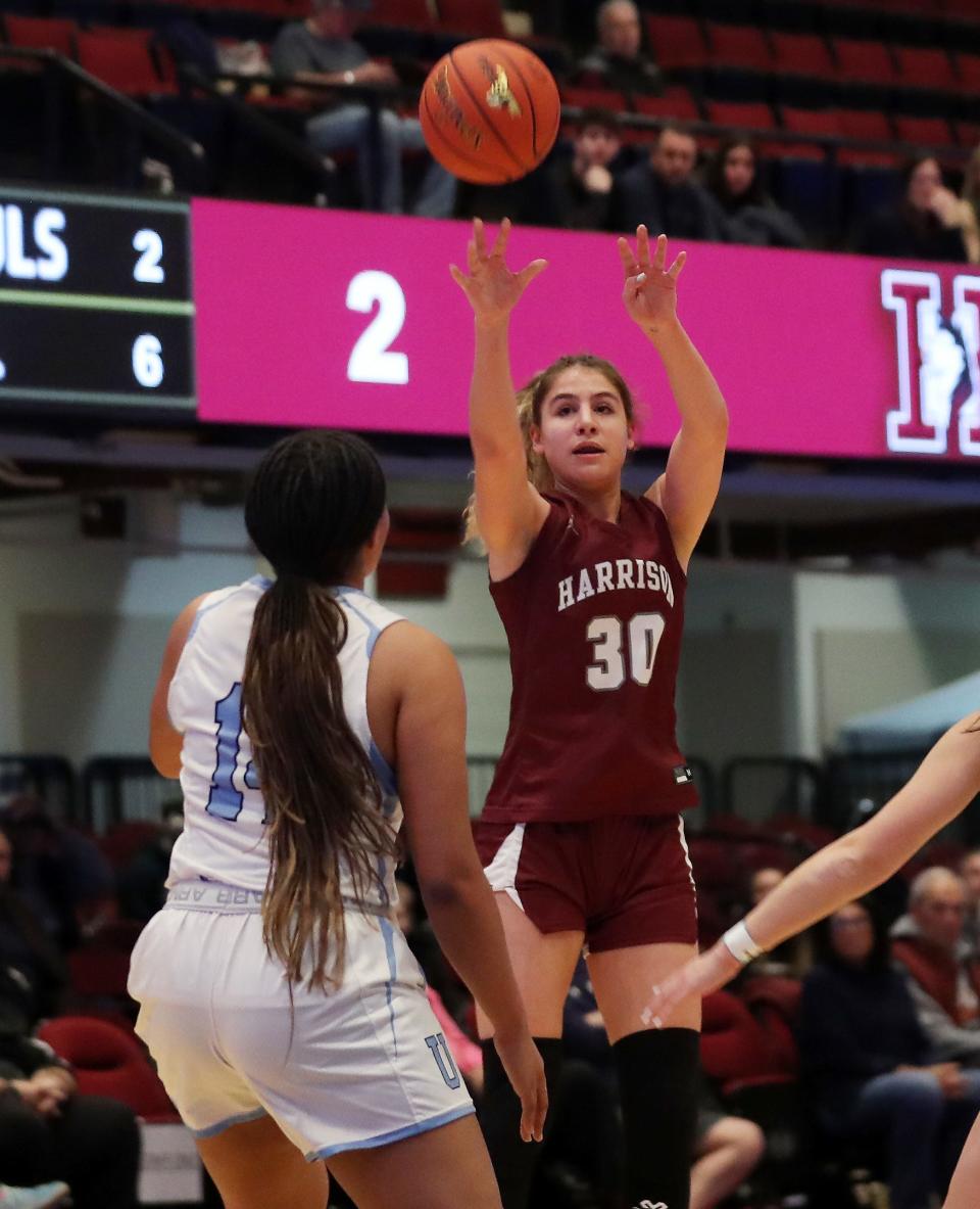 Harrison's Olivia Fernandez (30) puts up a shot in front of Ursuline's Madison Stores (14) during the Section1 Class AA girls basketball semifinal at the Westchester County Center in White Plains Feb. 27, 2024.