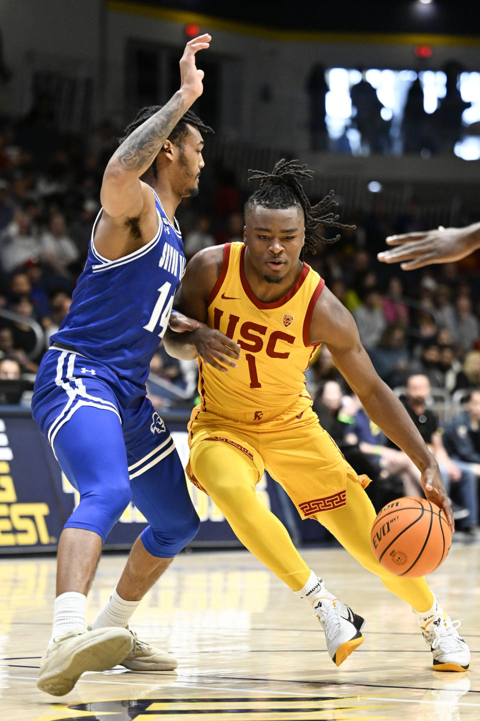 Southern California guard Isaiah Collier (1) drives past Seton Hall guard Dre Davis (14) during the first half of an NCAA college basketball game Thursday, Nov. 23, 2023, in San Diego. (AP Photo/Denis Poroy)