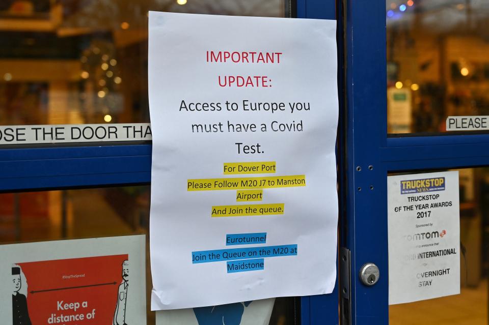 A sign alerting lorry drivers that they need to have a Covid-19 test before attempting to leave the UK for Europe, is pictured at the entrance to a truckstop service area, off of the M20 motorway that leads to Folkestone and Dover, near Ashford in Kent, south east England on December 22, 2020, after France closed its borders to accompanied freight arriving from the UK due to the rapid spread of a new coronavirus strain. - The British government said Tuesday it was considering tests for truckers as part of talks with French authorities to allow the resumption of freight traffic suspended due to a new coronavirus strain. Britain was plunged into fresh crisis last week with the emergence of a fresh strain of the virus, which is believed to be up to 70 percent more transmissible than other forms. (Photo by JUSTIN TALLIS / AFP) (Photo by JUSTIN TALLIS/AFP via Getty Images)