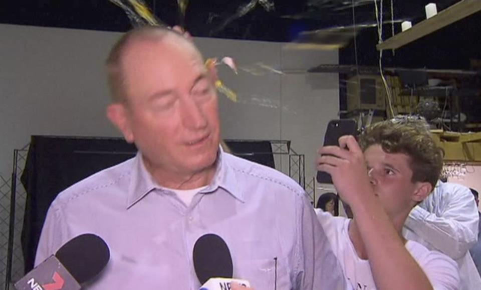 Will Connolly, also known as ‘Egg Boy’, smashes an egg over the head of Senator Fraser Anning at an event in Melbourne. Source: 7 News