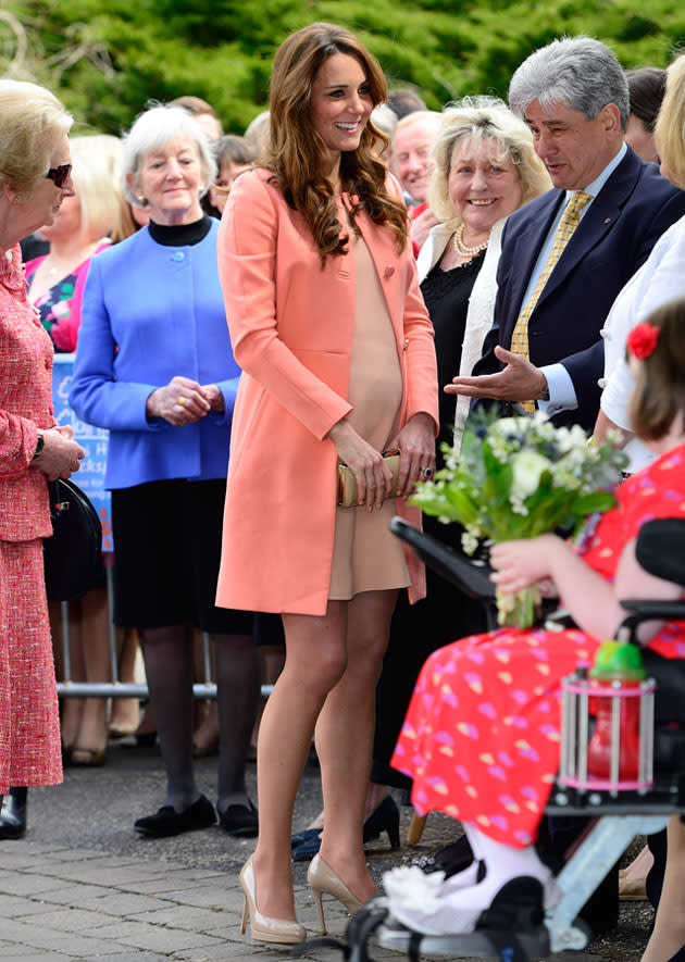 Kate Middleton dressed her baby bump in peach and pink hues for another royal outing - and looked gorgeous. Copyright [Splash]