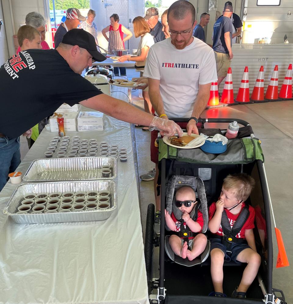 Members of the Graafschap Fire Department serve up breakfast to hundreds of people on Monday, July 4, at the annual pancake breakfast at the fire station, 4534 60th St.