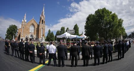 Emergency responders form an honor guard prior to a memorial mass at the Sainte-Agnes church in Lac-Megantic, July 6, 2014. REUTERS/Mathieu Belanger
