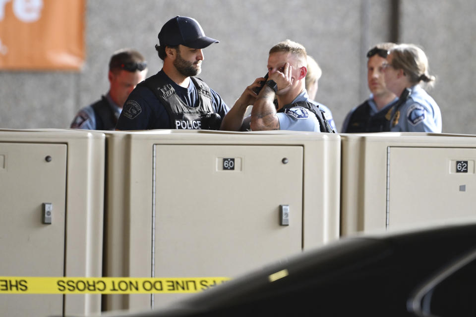 Members of law enforcement gather outside Hennepin County Medical Center in Minneapolis, Thursday, May 30, 2024, following a fatal shooting. (Aaron Lavinsky/Star Tribune via AP)