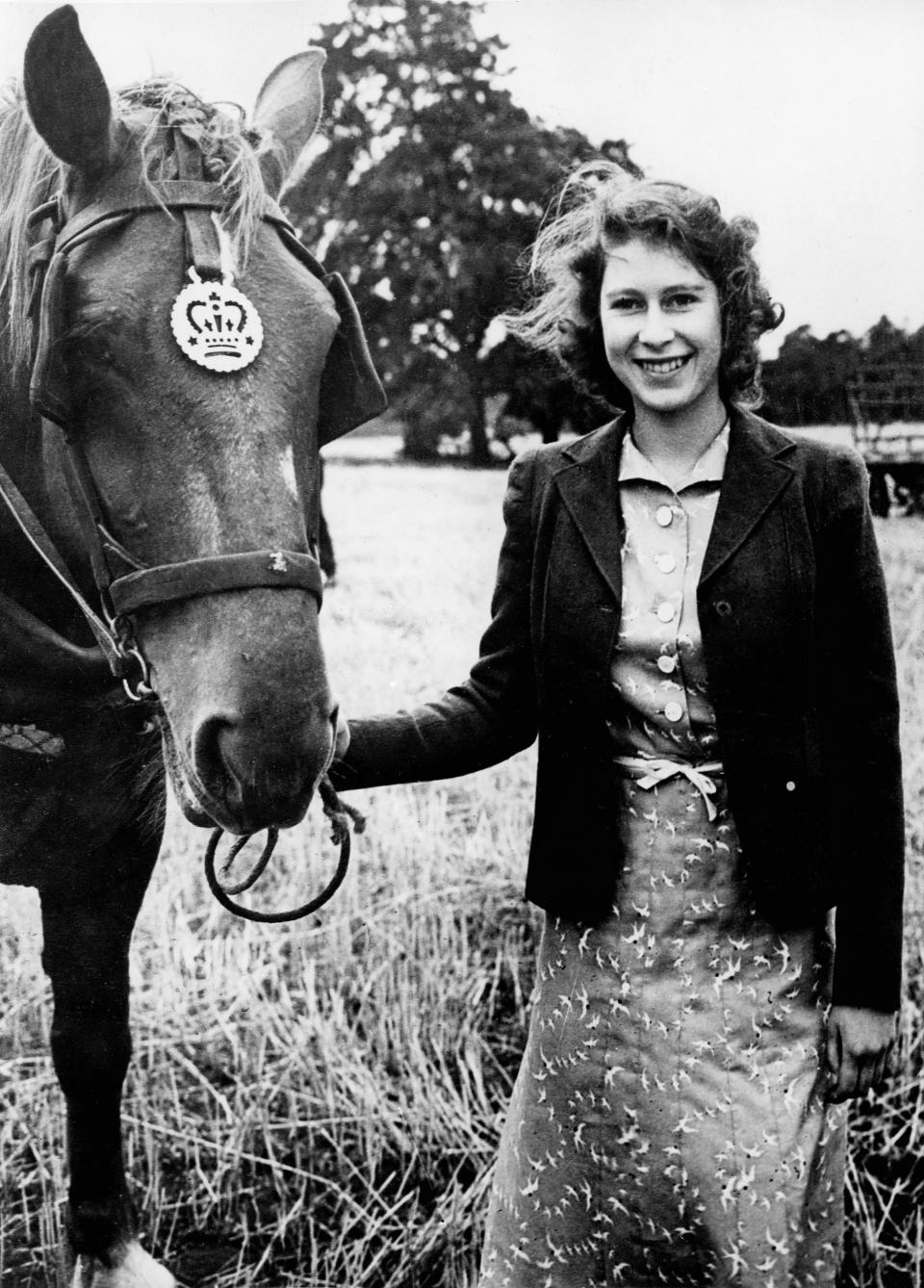 A then Princess Elizabeth with one of her horses, in around 1940 [Photo: Getty]