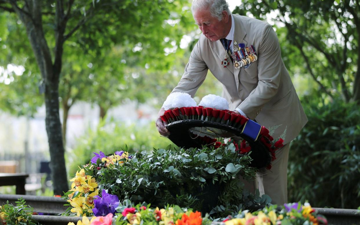 The Prince of Wales lays a wreath during the national service of remembrance - PA