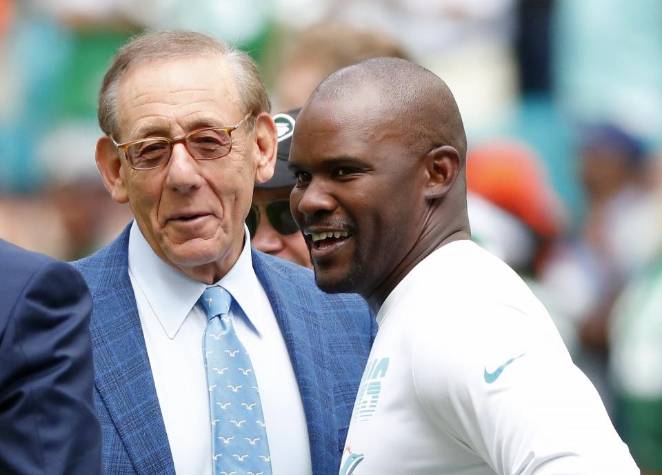 FILE -Miami Dolphins head coach Brian Flores talks to Miami Dolphins owner Stephen M. Ross during practice before an NFL football game against the New York Jets, Sunday, Nov. 3, 2019, in Miami Gardens, Fla. Fired Miami Dolphins coach Brian Flores sued the NFL and three of its teams Tuesday, Feb. 1, 2022 saying racist hiring practices by the league have left it racially segregated and managed like a plantation.