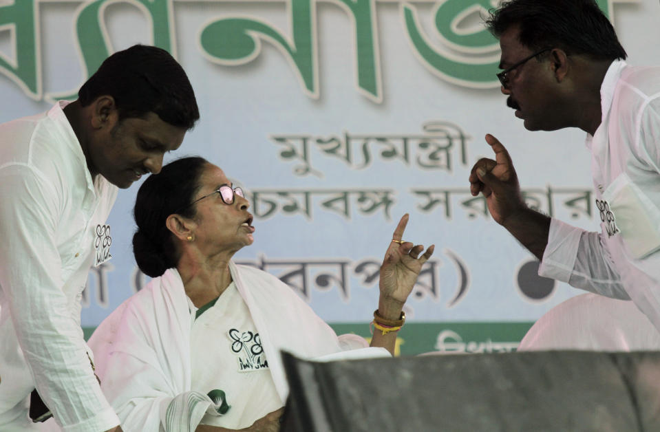 Trinamool Congress leader and Chief Minister of West Bengal state Mamata Banerjee talks to a party member at an election rally at Anchana in Mathurapur, about 60 kilometers south of Kolkata, India, Thursday, May 16, 2019. With 900 million of India's 1.3 billion people registered to vote, the Indian national election is the world's largest democratic exercise. The seventh and last phase of the elections will be held on Sunday. (AP Photo/Bikas Das)