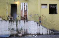 <p>A boy walks down the stairs in a set of occupied buildings in the Mangueira favela, May 4, 2017, in Rio de Janeiro. (Photo: Mario Tama/Getty Images) </p>