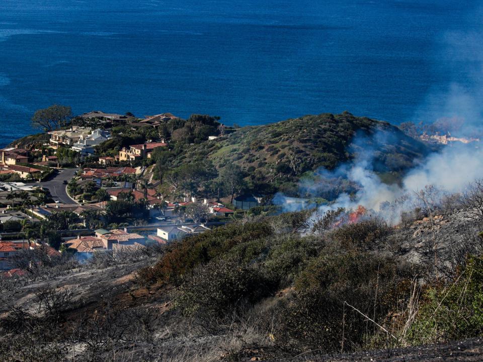 Smoke billows above expensive real estate.