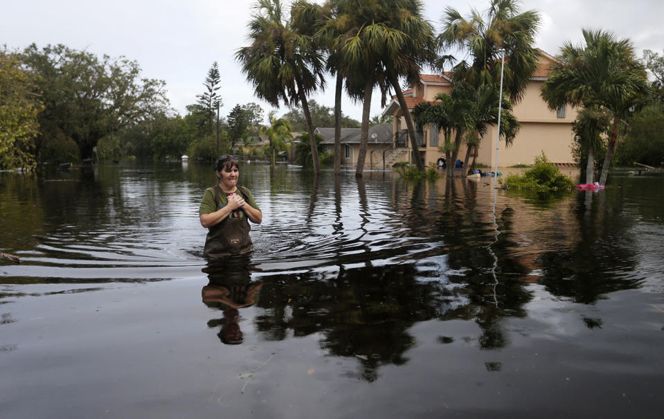 <p><strong>Bonita Springs</strong><br>Kelly McClenthen walks through her flooded neighborhood, as she returns to see the damage to her home in the aftermath of Hurricane Irma in Bonita Springs, Fla., Sept. 11, 2017. (Photo: Gerald Herbert/AP) </p>